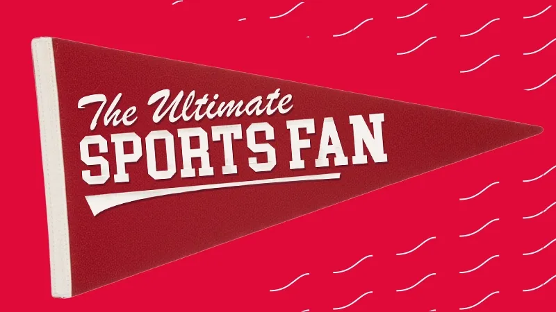 red felt sports pennant featuring the text "The Ultimate Sports Fan" in white lettering against a red background with white wave patterns.